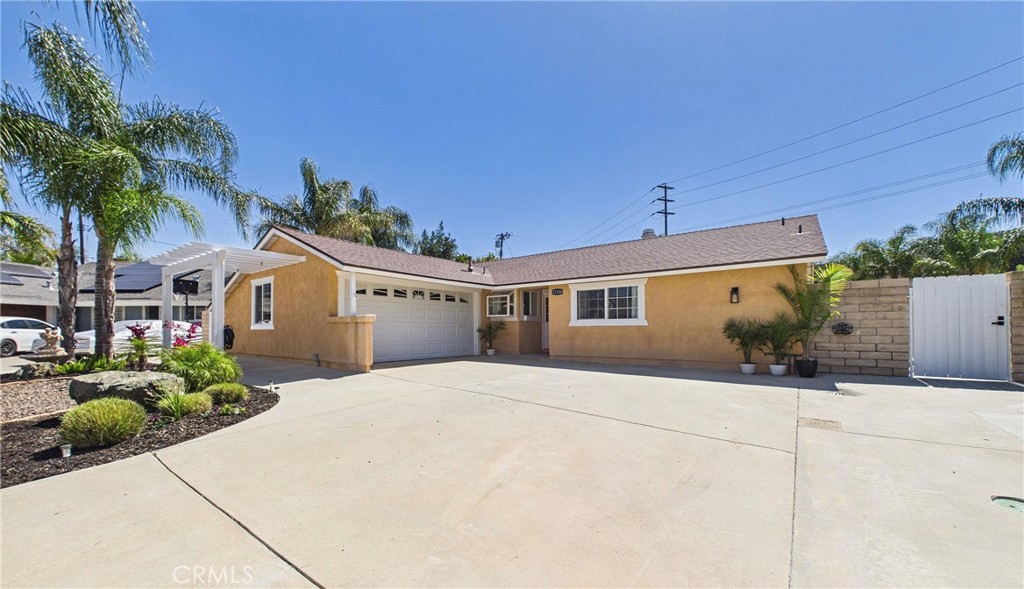 21104 Rosedell Drive Saugus, CA 91350 - Photo 4 of 33 Front exterior with mature palms and expansive driveway