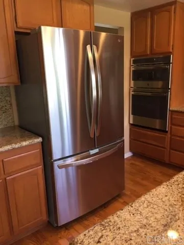 a metallic refrigerator freezer sitting in a kitchen
