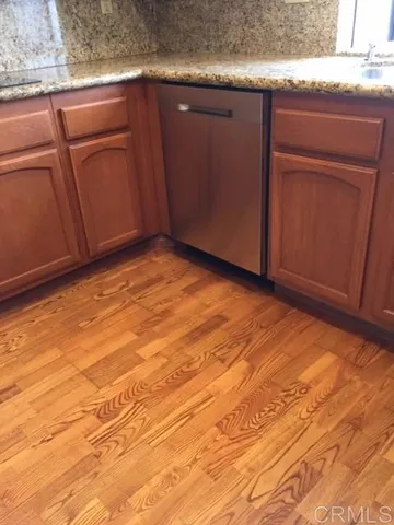 a view of empty room with kitchen