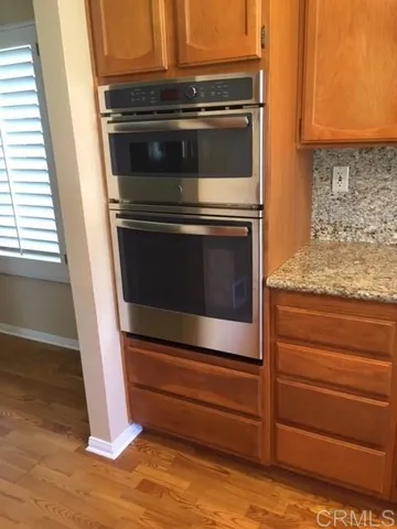 a stove top oven sitting inside of a kitchen