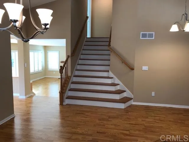 a view of entryway and hall with wooden floor
