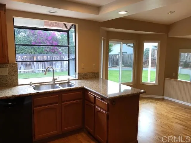 a kitchen with a sink and large window
