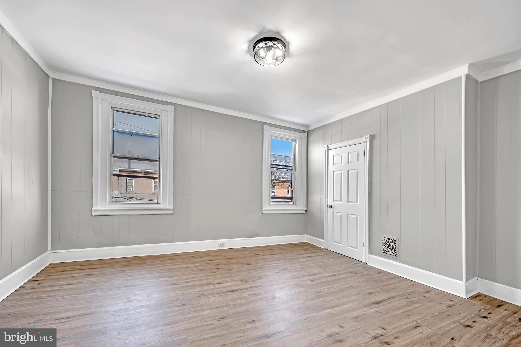 25 Adella Avenue Hamilton, NJ 08609 - Photo 11 of 15 a view of an empty room with wooden floor and a window