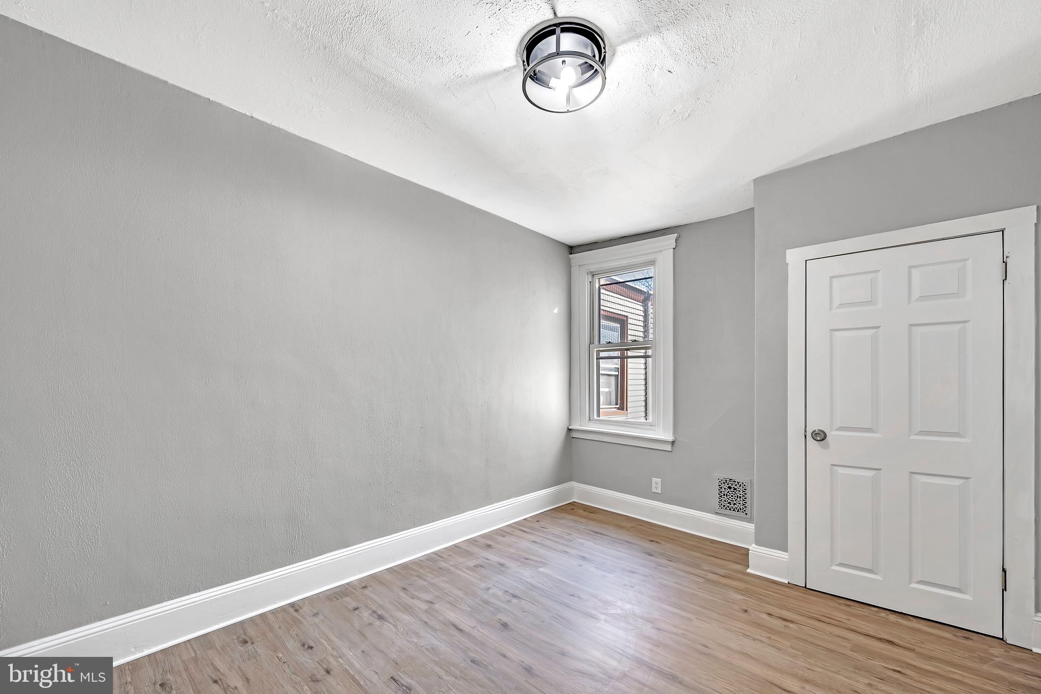 25 Adella Avenue Hamilton, NJ 08609 - Photo 12 of 15 an empty room with wooden floor and windows