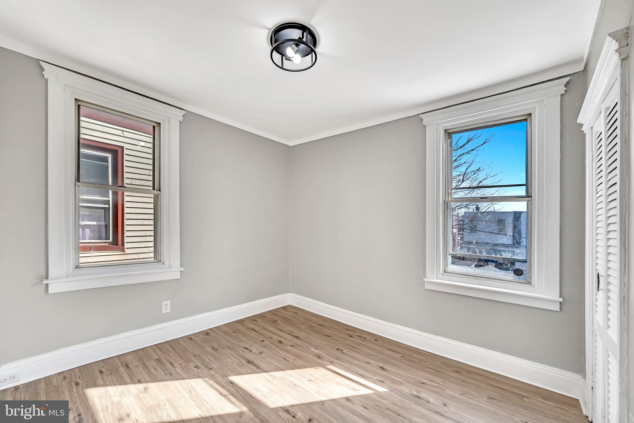 25 Adella Avenue Hamilton, NJ 08609 - Photo 13 of 15 a view of an empty room with a window and wooden floor