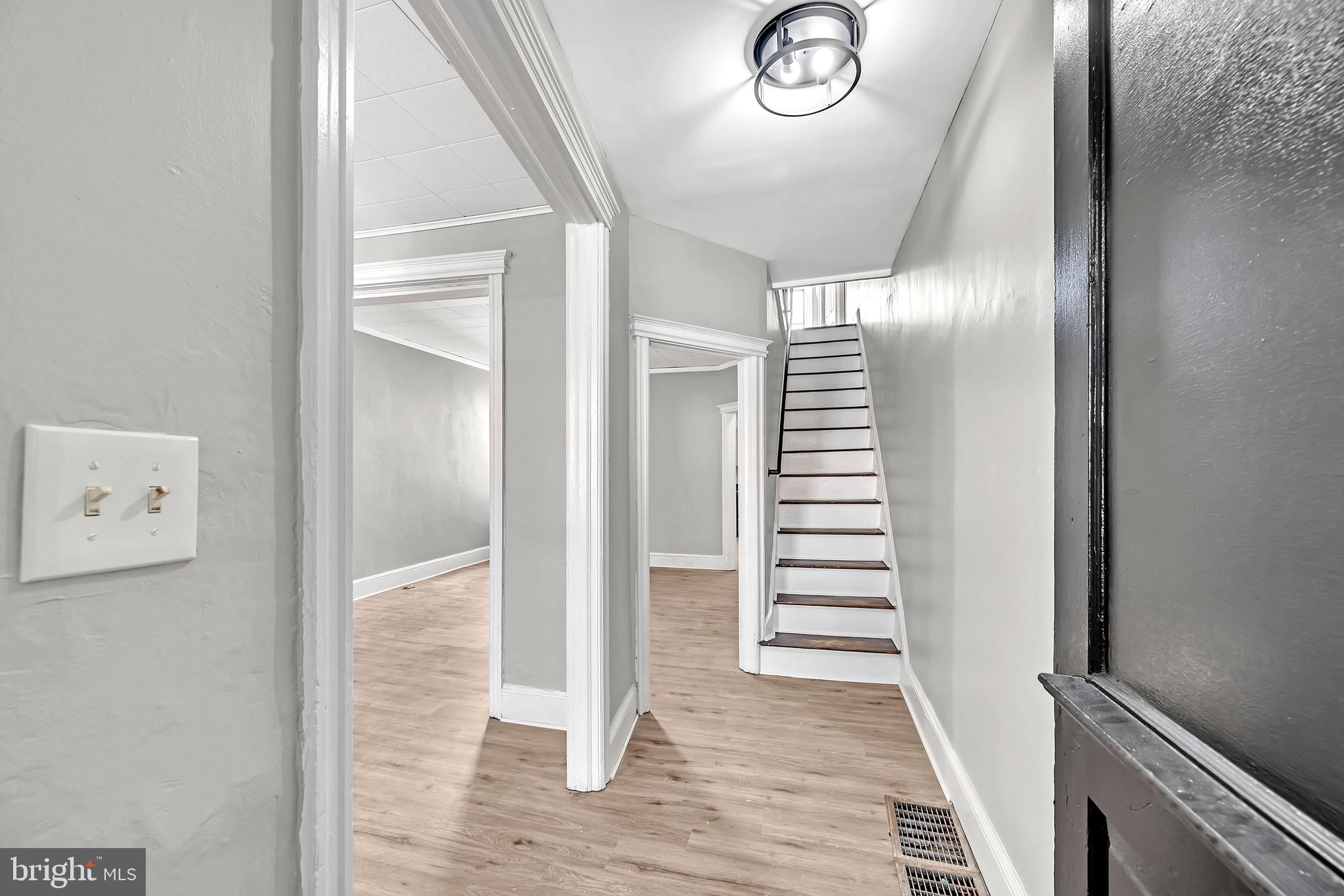 25 Adella Avenue Hamilton, NJ 08609 - Photo 3 of 15 a view of a hallway with entryway wooden floor and front door