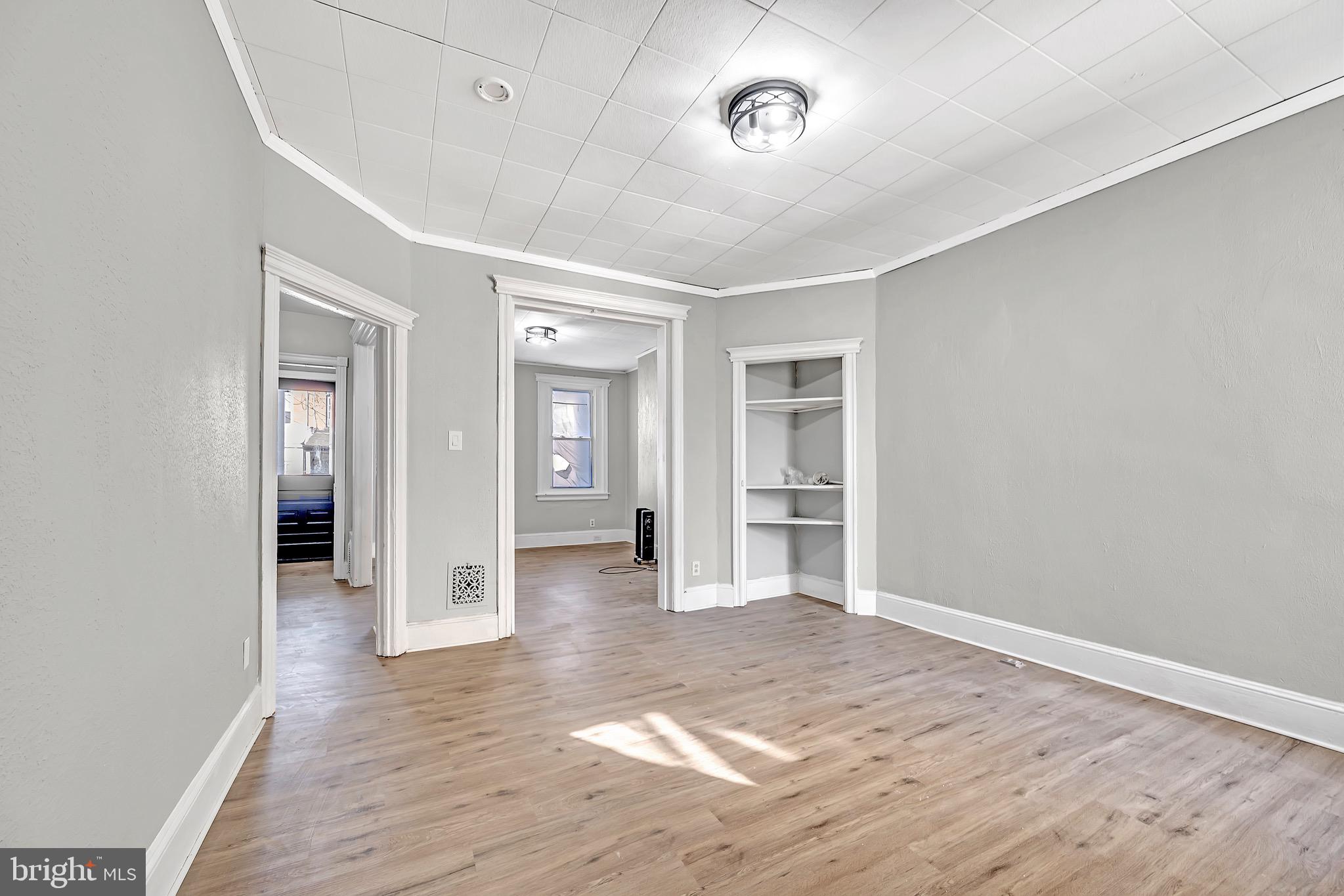 25 Adella Avenue Hamilton, NJ 08609 - Photo 5 of 15 an empty room with wooden floor and windows