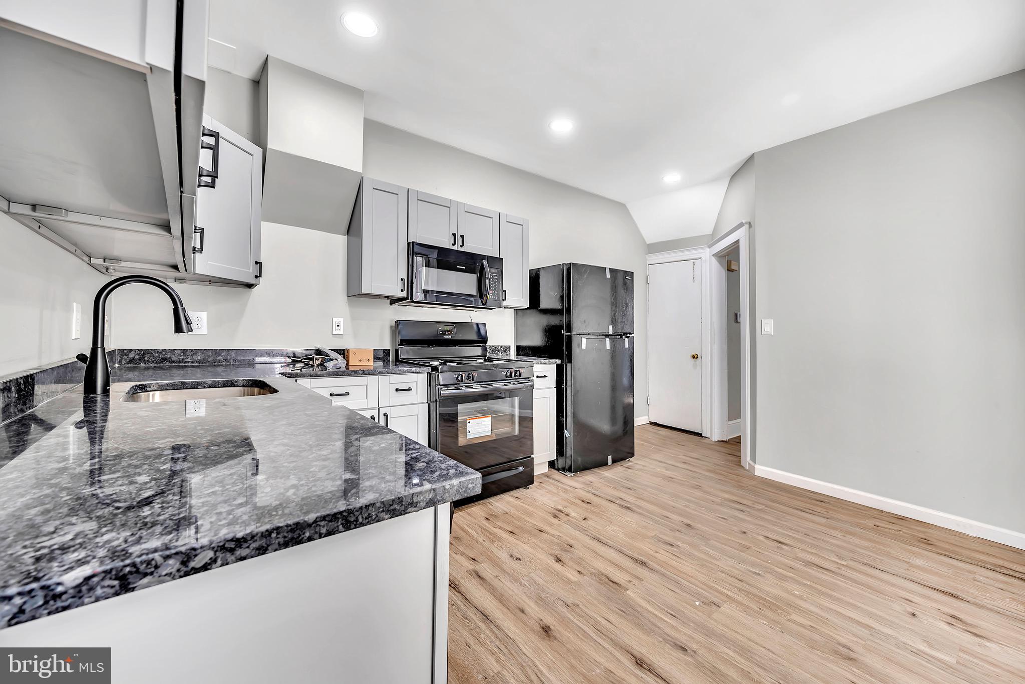 25 Adella Avenue Hamilton, NJ 08609 - Photo 7 of 15 a kitchen with stainless steel appliances granite countertop a sink refrigerator and microwave