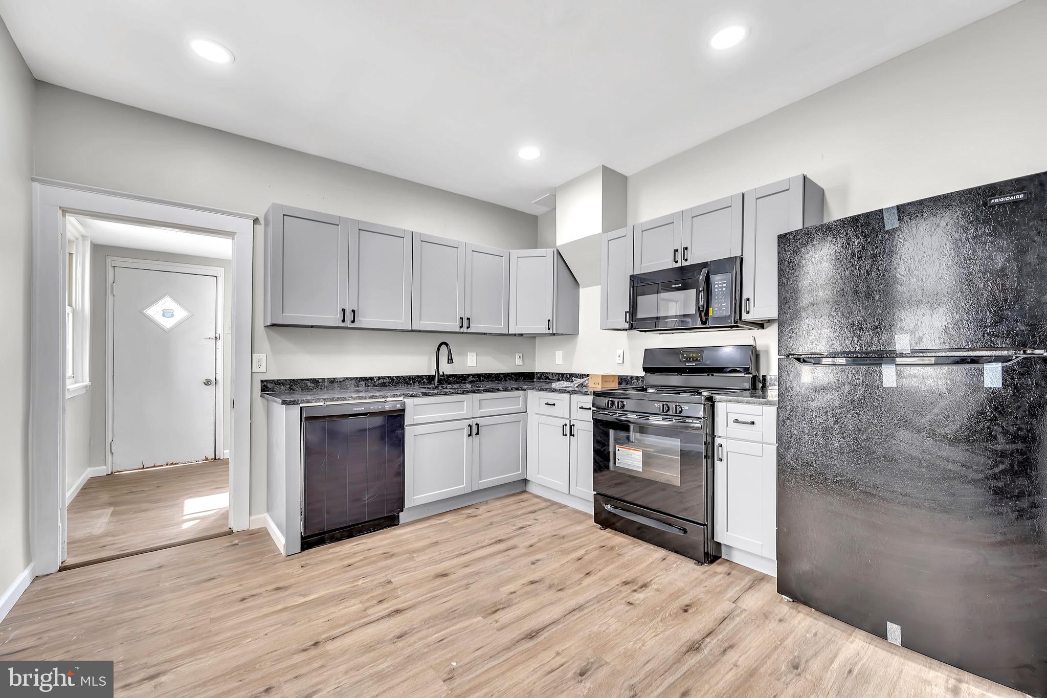 25 Adella Avenue Hamilton, NJ 08609 - Photo 9 of 15 a kitchen with granite countertop a refrigerator stove and sink