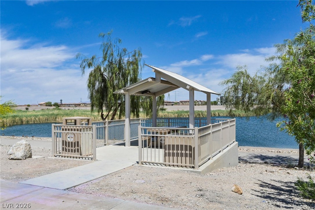 155 Fulgora Street Henderson, NV 89074 - Photo 25 of 30 A tranquil lakeside gazebo offers a serene spot for relaxation amidst natural beauty.
