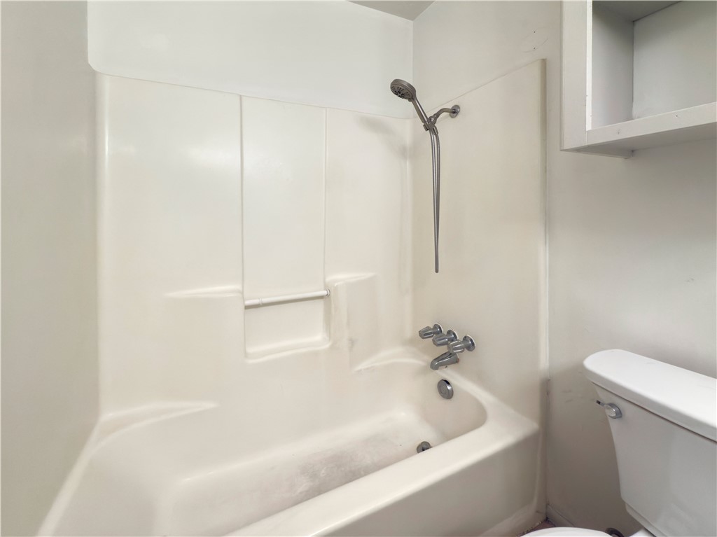3003 Highwood Lane Bryan, TX 77803 - Photo 10 of 21 a white bath tub sitting next to a white toilet and vanity