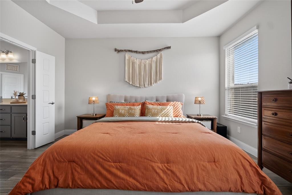 2252 Knightsgate Road Argyle, TX 76226 - Photo 16 of 36 Bedroom with a tray ceiling and dark wood-style floors