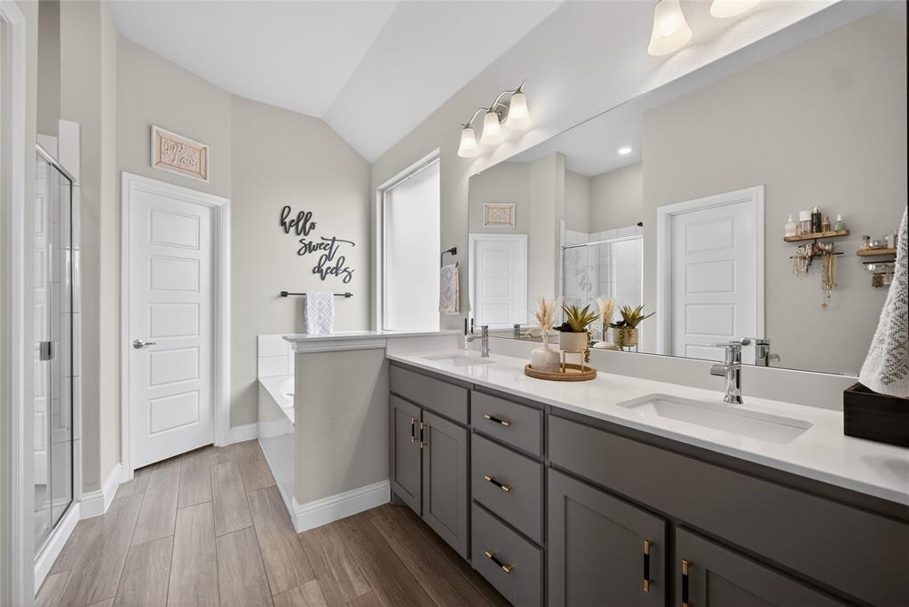 2252 Knightsgate Road Argyle, TX 76226 - Photo 18 of 36 Full bath featuring a stall shower, double vanity, a bath, dark wood finished floors, and lofted ceiling