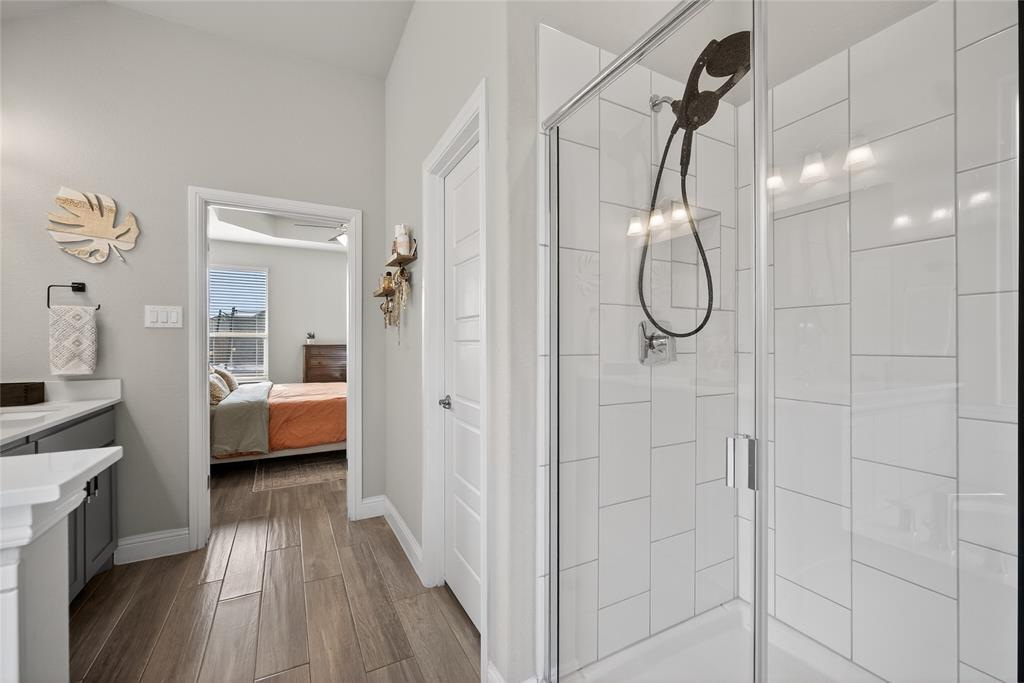 2252 Knightsgate Road Argyle, TX 76226 - Photo 19 of 36 Ensuite bathroom with vanity, a shower stall, and dark wood-type flooring