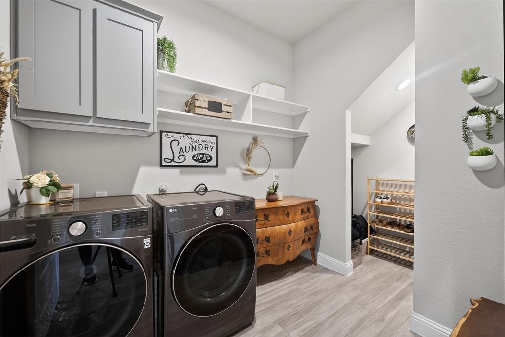 2252 Knightsgate Road Argyle, TX 76226 - Photo 24 of 36 Laundry room featuring cabinet space, light wood finished floors, and washer and clothes dryer