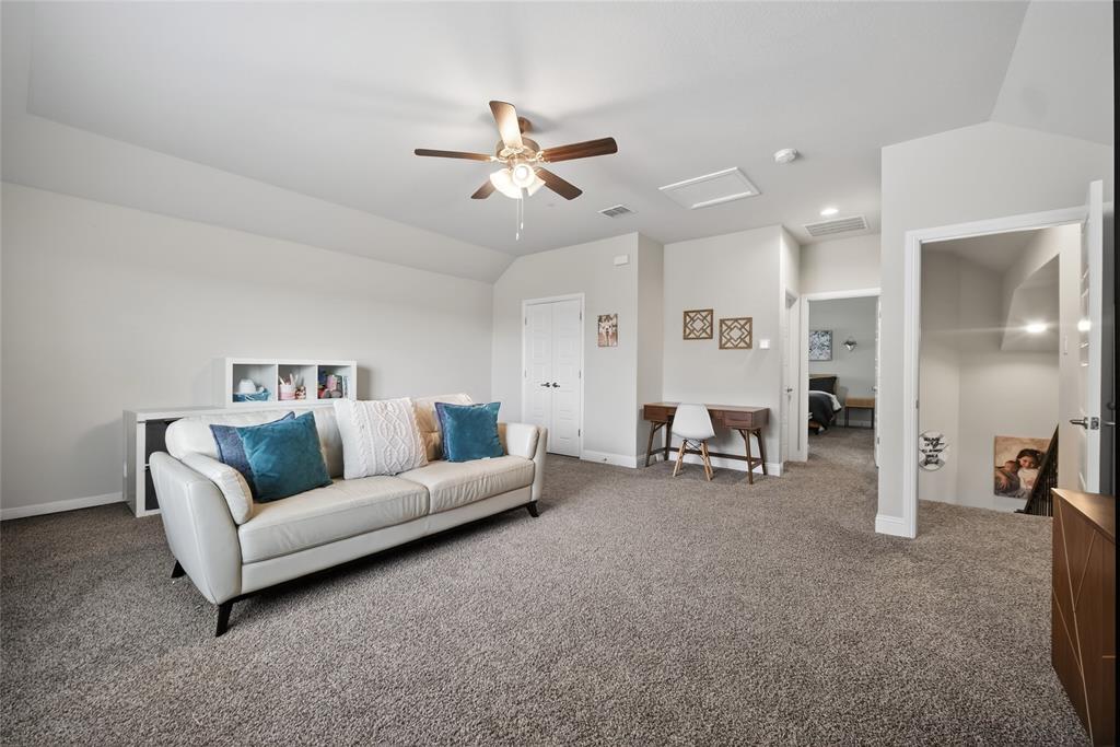 2252 Knightsgate Road Argyle, TX 76226 - Photo 28 of 36 Living area with a ceiling fan, carpet flooring, and vaulted ceiling