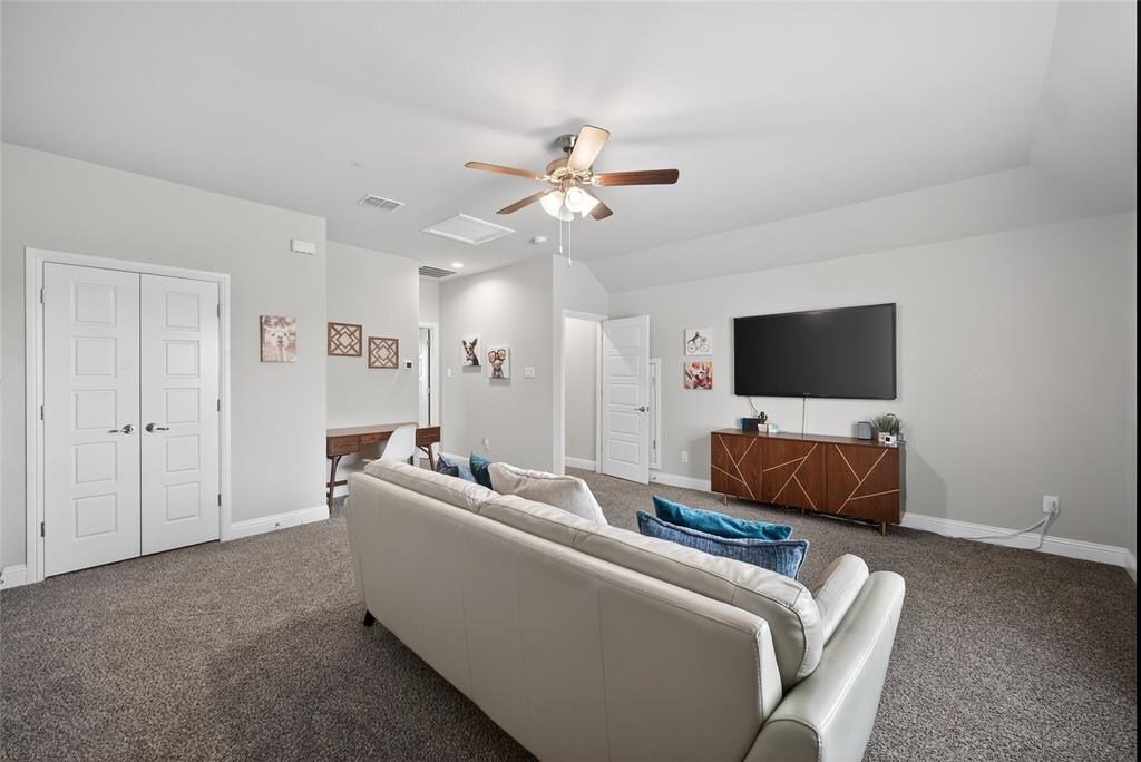 2252 Knightsgate Road Argyle, TX 76226 - Photo 29 of 36 Carpeted living room with a ceiling fan and vaulted ceiling