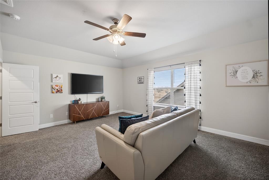 2252 Knightsgate Road Argyle, TX 76226 - Photo 30 of 36 Carpeted living room featuring baseboards and ceiling fan