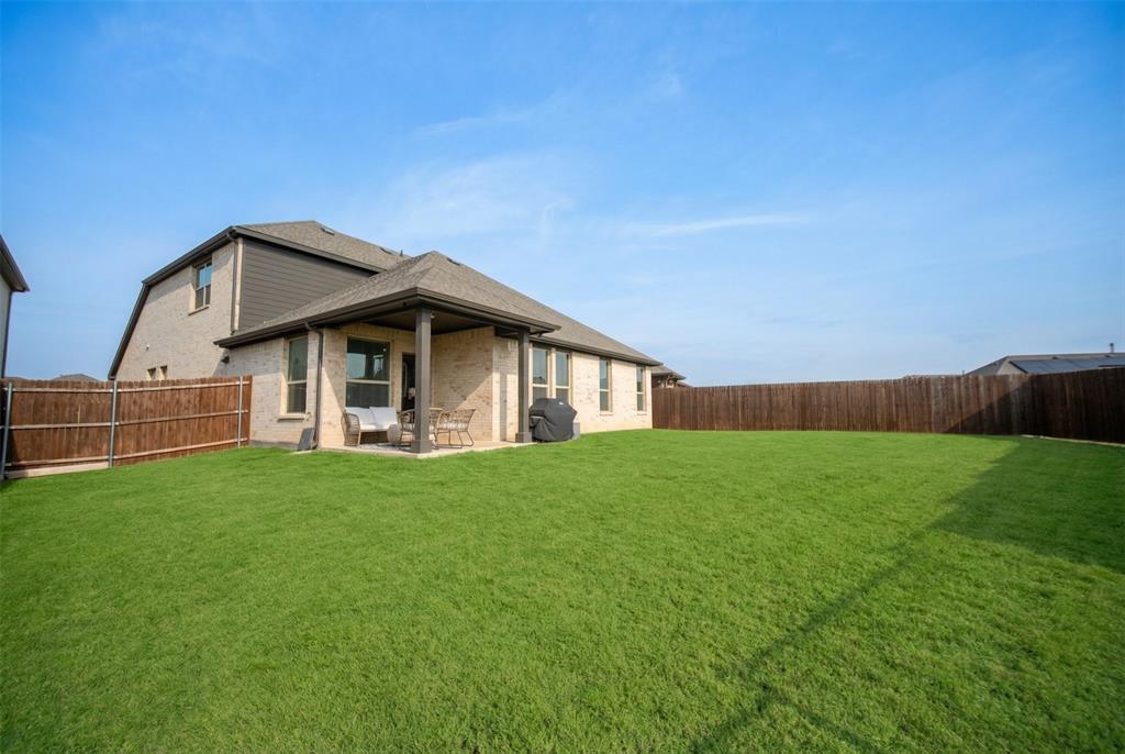 2252 Knightsgate Road Argyle, TX 76226 - Photo 32 of 36 Rear view of property with a patio, a fenced backyard, brick siding, and roof with shingles