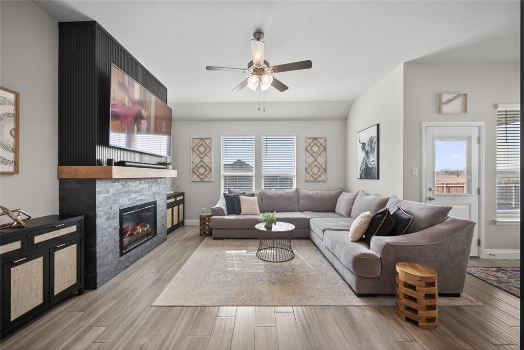 2252 Knightsgate Road Argyle, TX 76226 - Photo 4 of 36 Living room featuring ceiling fan, light wood finished floors, and a stone fireplace