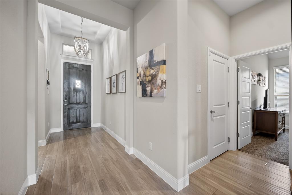 2252 Knightsgate Road Argyle, TX 76226 - Photo 5 of 36 Foyer with light wood finished floors and hanging lights