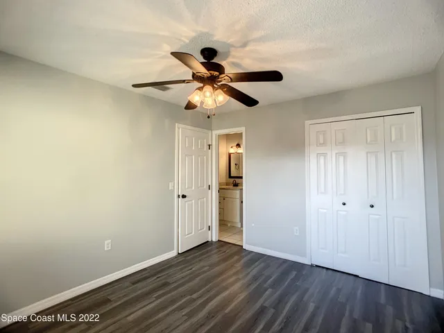 a view of an empty room and wooden floor