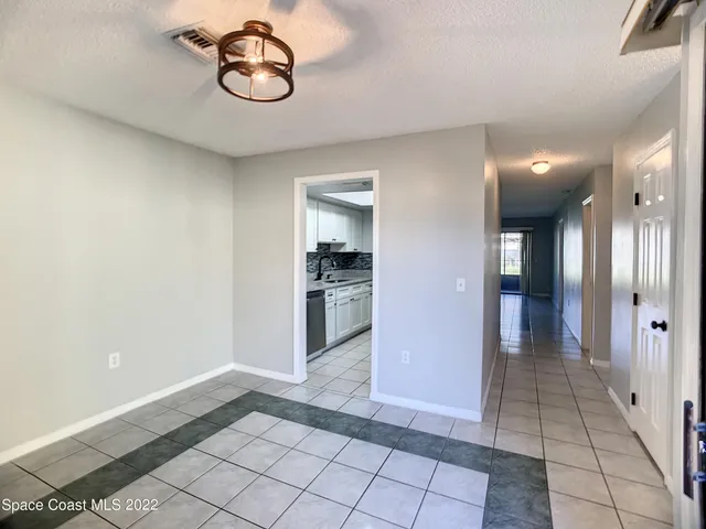 a view of livingroom with hallway and chandelier