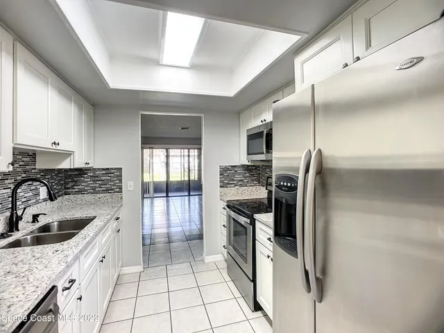 a kitchen with a sink stove and refrigerator