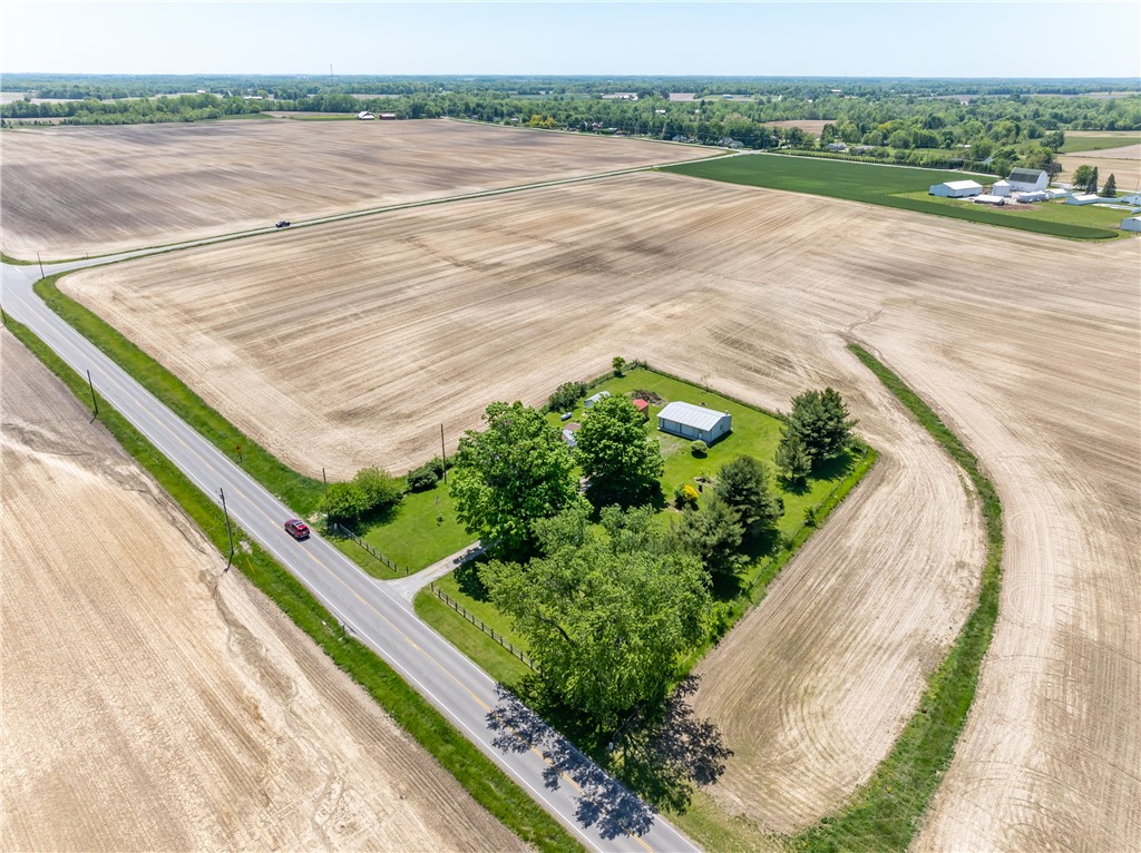 1217 Jasper Road Xenia, OH 45385 - Photo 8 of 62 This expansive aerial view showcases a secluded property surrounded by vast, open fields.