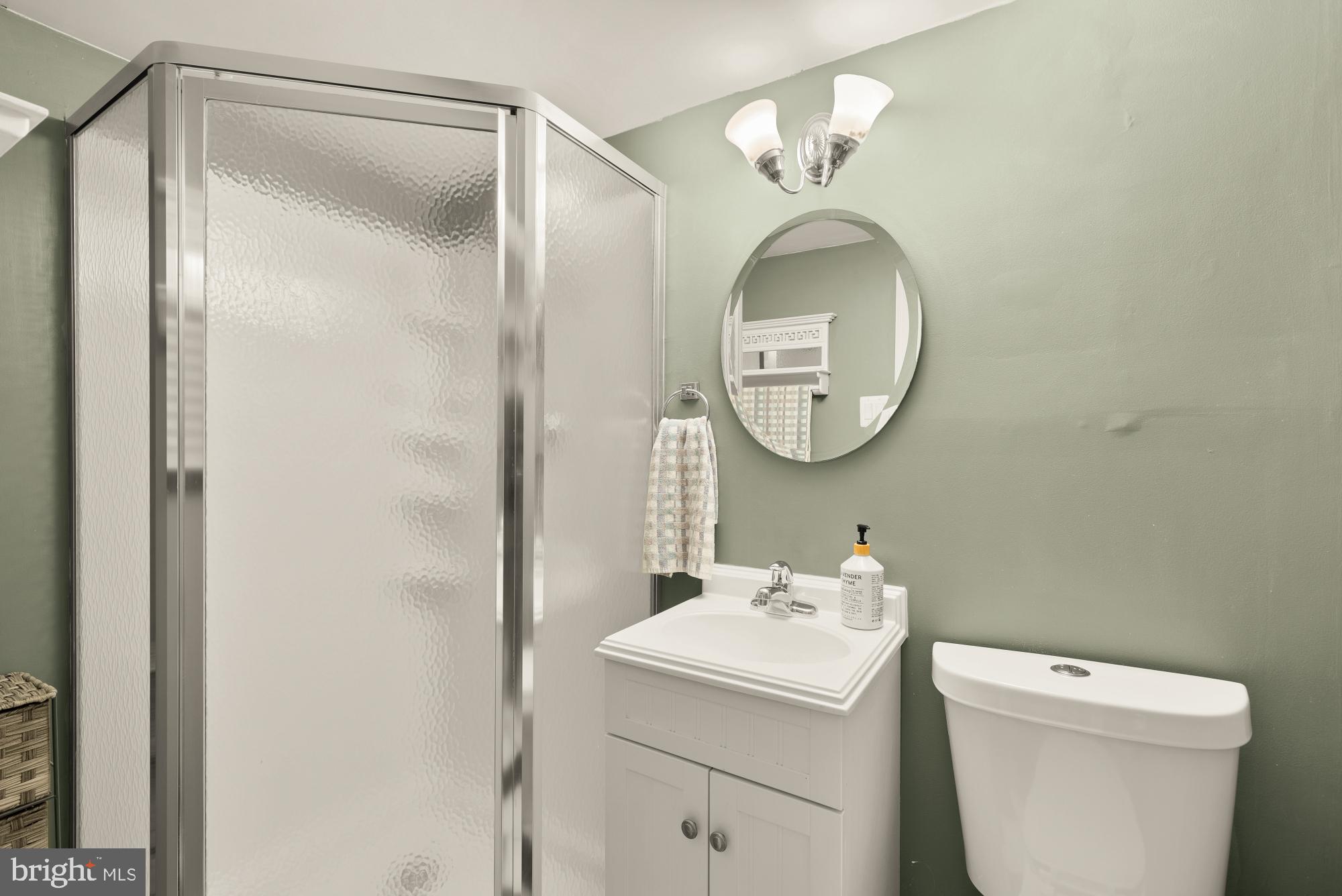 8100 Loving Forest Court Springfield, VA 22153 - Photo 27 of 33 a bathroom with a toilet a sink and a mirror
