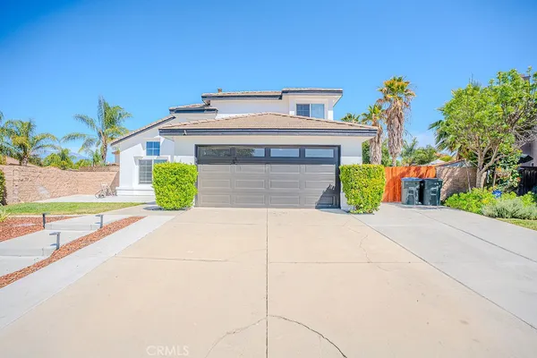 a front view of a house with a yard and a garage