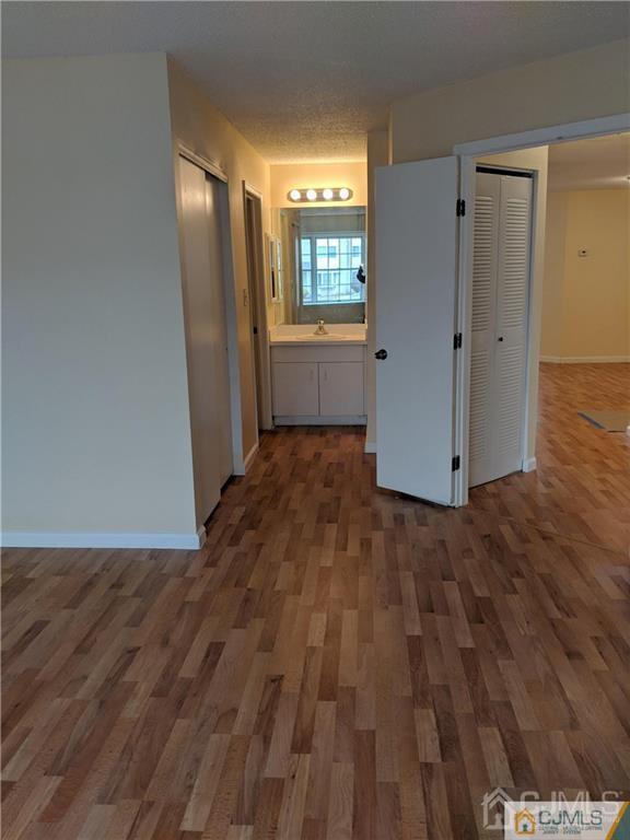 1223 Edpas Road, Unit 1223 New Brunswick, NJ 08901 - Photo 11 of 18 an empty room with wooden floor and windows