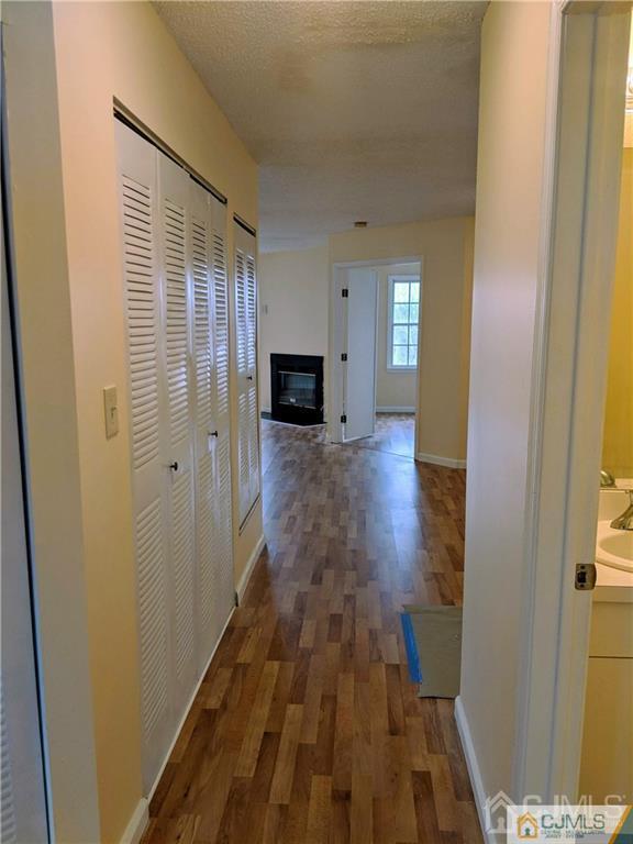 1223 Edpas Road, Unit 1223 New Brunswick, NJ 08901 - Photo 13 of 18 a view of a hallway with wooden floor and staircase
