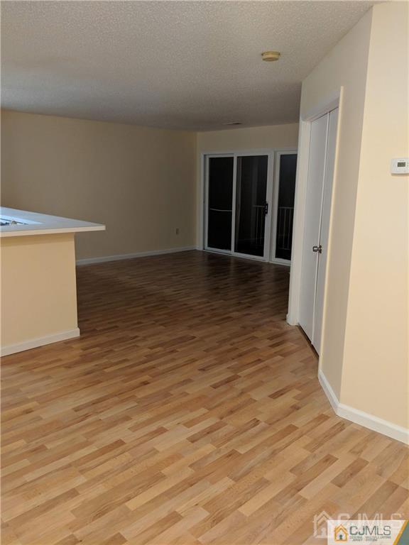 1223 Edpas Road, Unit 1223 New Brunswick, NJ 08901 - Photo 3 of 18 wooden floor in an empty room