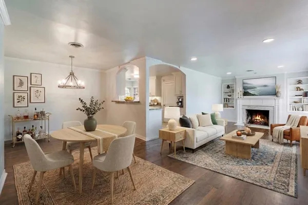 a living room with furniture a fireplace and a table