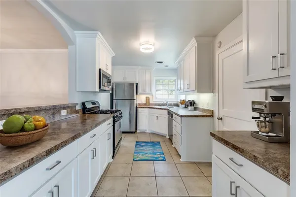 a kitchen with a sink appliances and cabinets