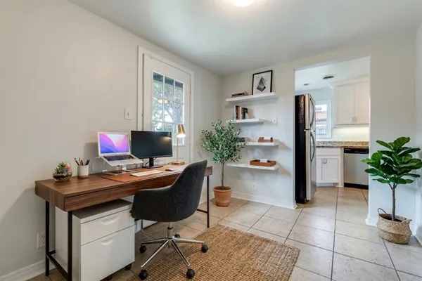 a view of a workspace with furniture and a potted plant