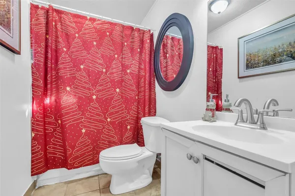a bathroom with a toilet a sink and a mirror