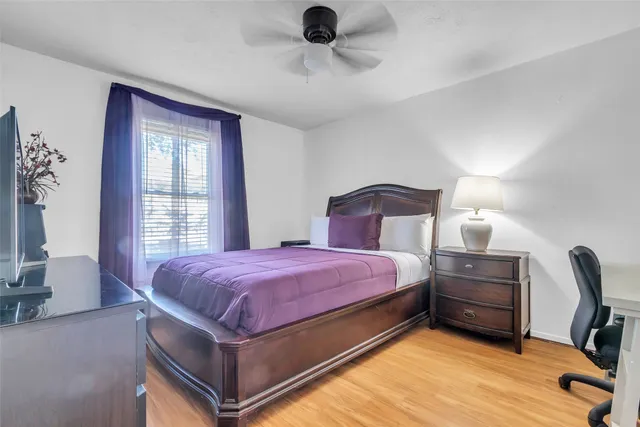 a bedroom with a bed and a tv on the dresser