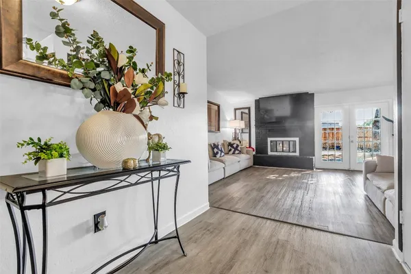 a living room with furniture and a potted plant