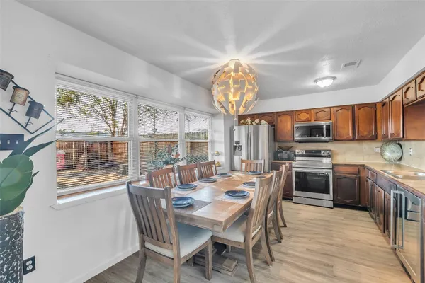 a view of a dining room with furniture large window and wooden floor