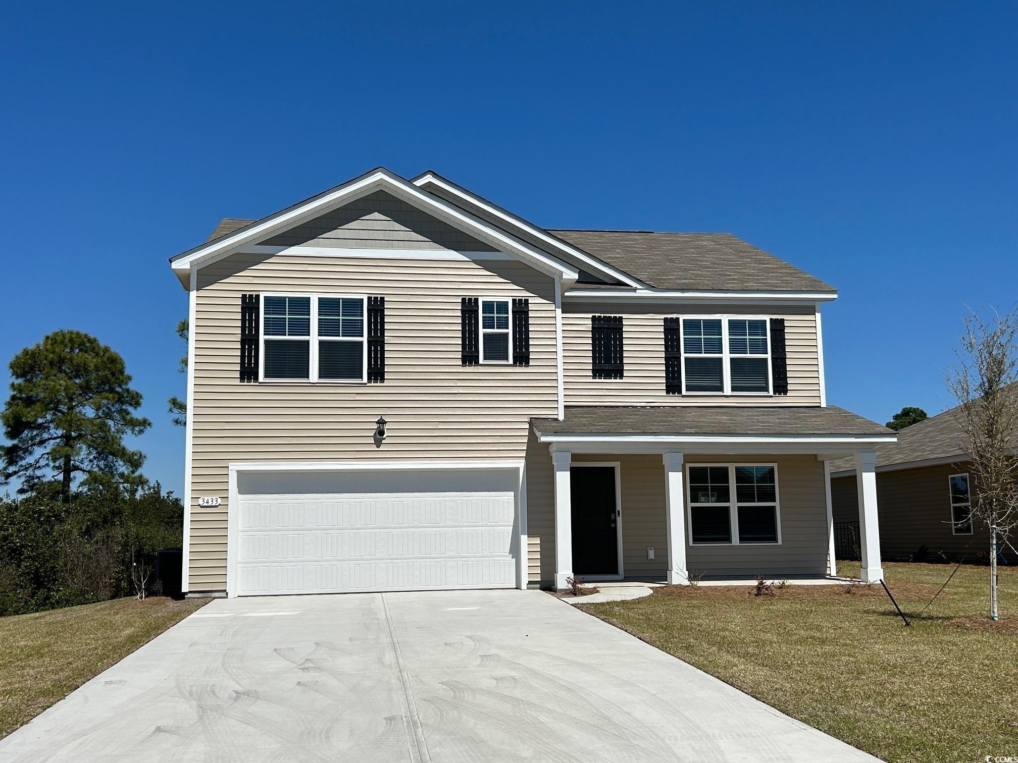 View of front of property featuring an attached ga