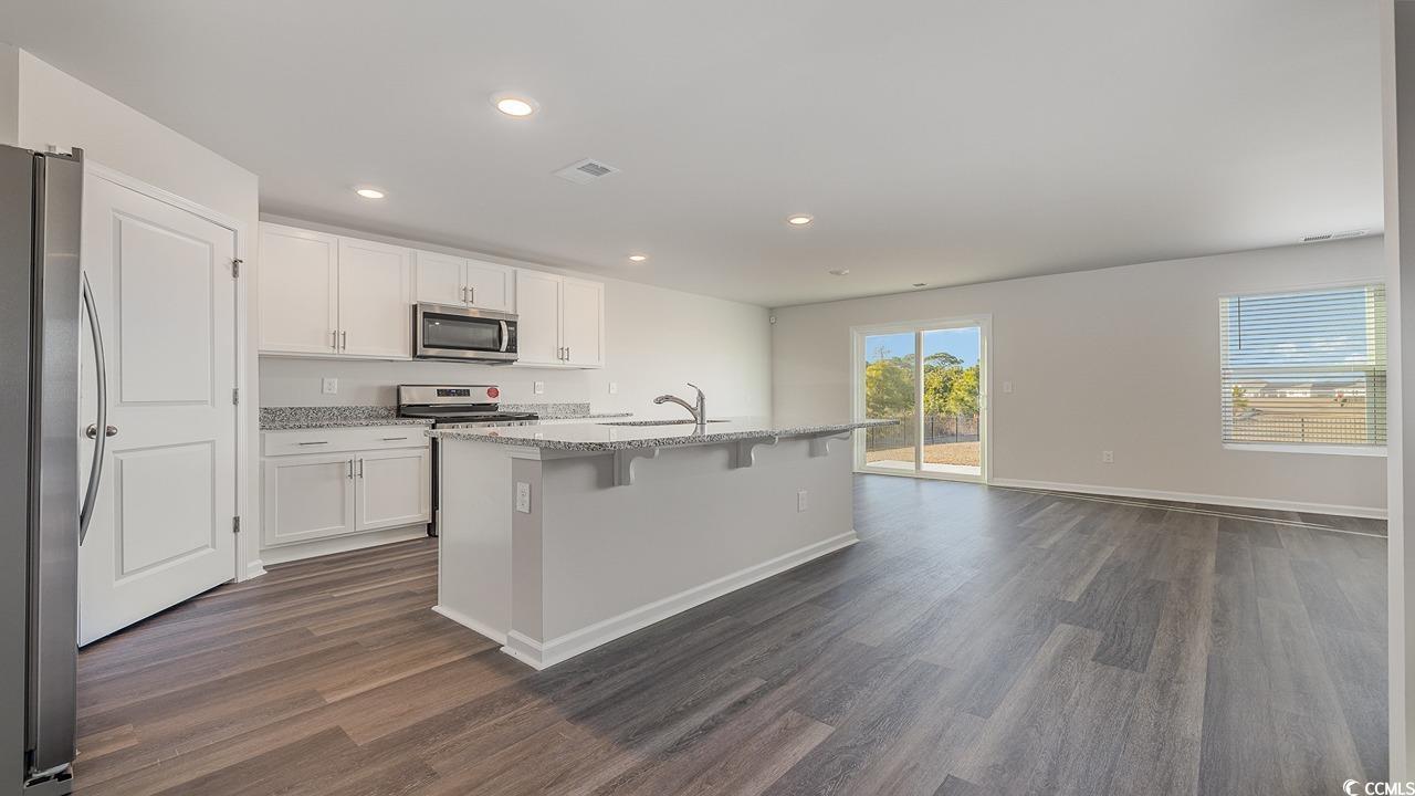 3433 Ashridge Way Conway, SC 29526 - Photo 6 of 31 Kitchen with white cabinetry, appliances with stai