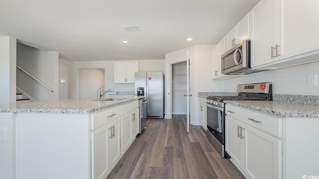 3433 Ashridge Way Conway, SC 29526 - Photo 9 of 31 Kitchen featuring sink, white cabinetry, wood-type