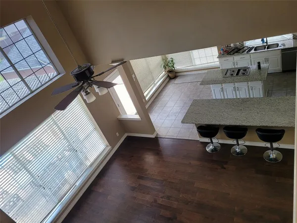a kitchen with granite countertop a refrigerator and a sink