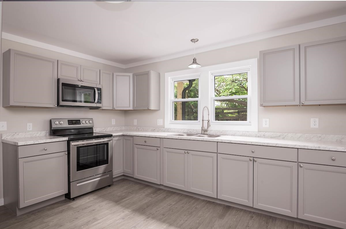 314 Depot Street Roxboro, NC 27573 - Photo 11 of 35 a kitchen with sink a microwave and cabinets