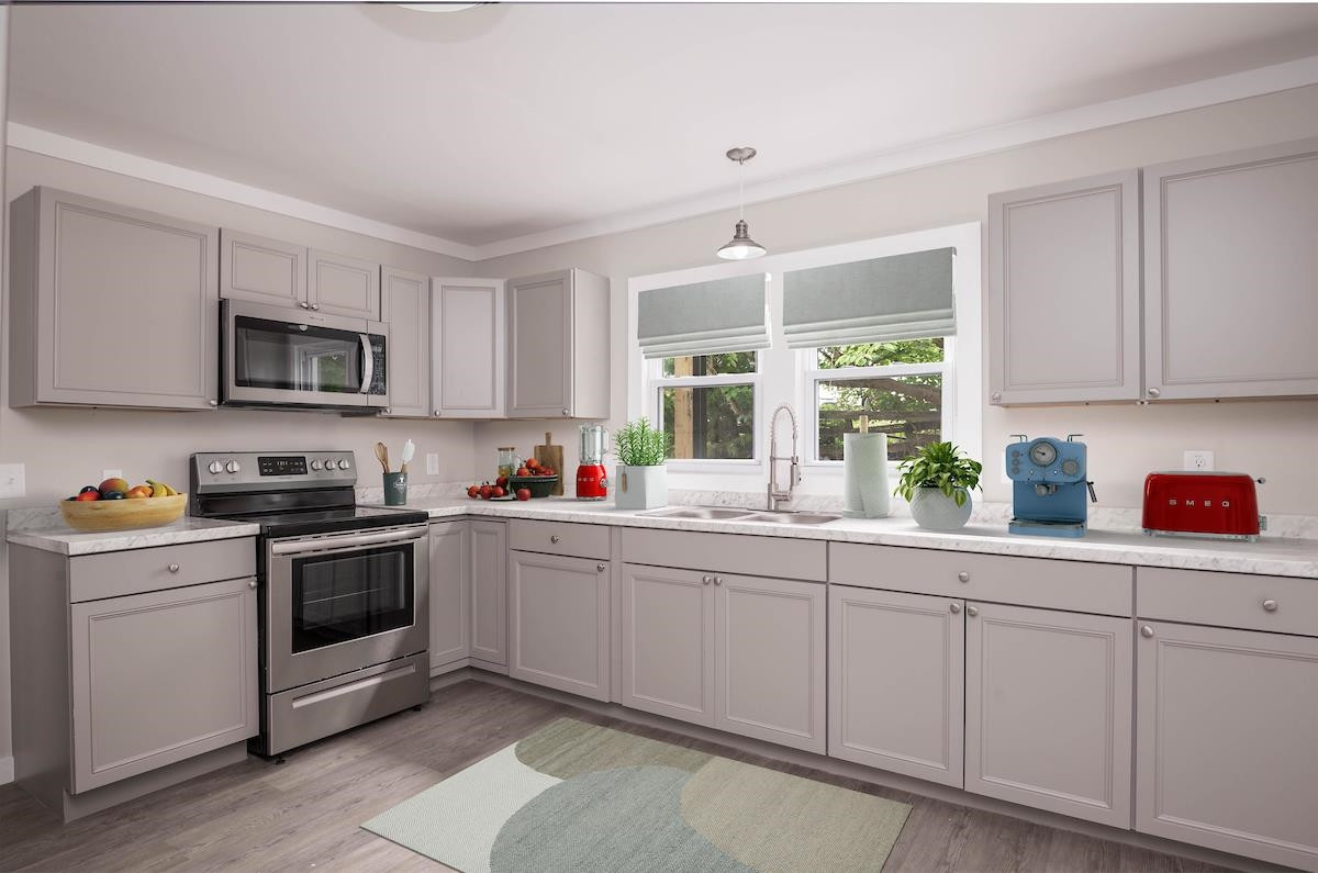 314 Depot Street Roxboro, NC 27573 - Photo 12 of 35 a kitchen with sink a microwave and cabinets
