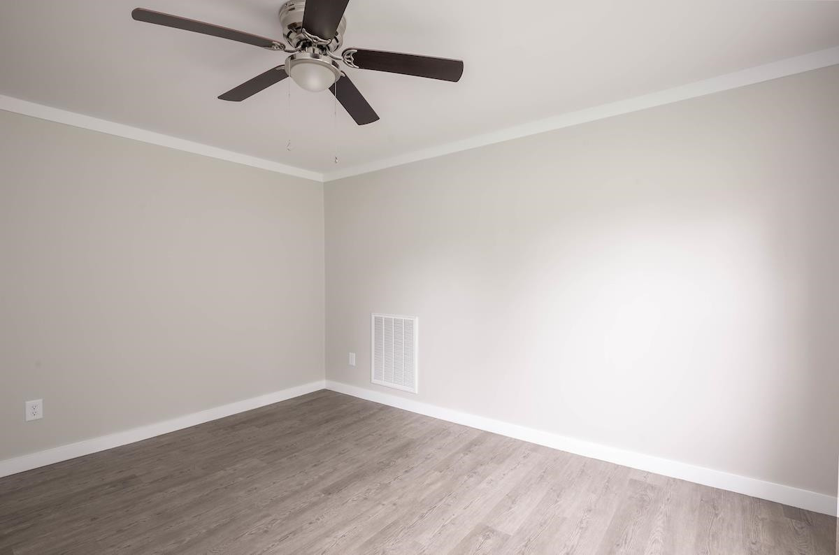 314 Depot Street Roxboro, NC 27573 - Photo 15 of 35 an empty room with wooden floor ceiling fan and window