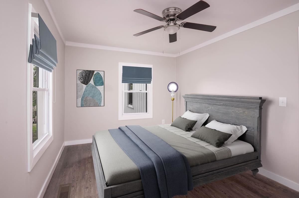 314 Depot Street Roxboro, NC 27573 - Photo 20 of 35 a bedroom with a large bed and a chandelier