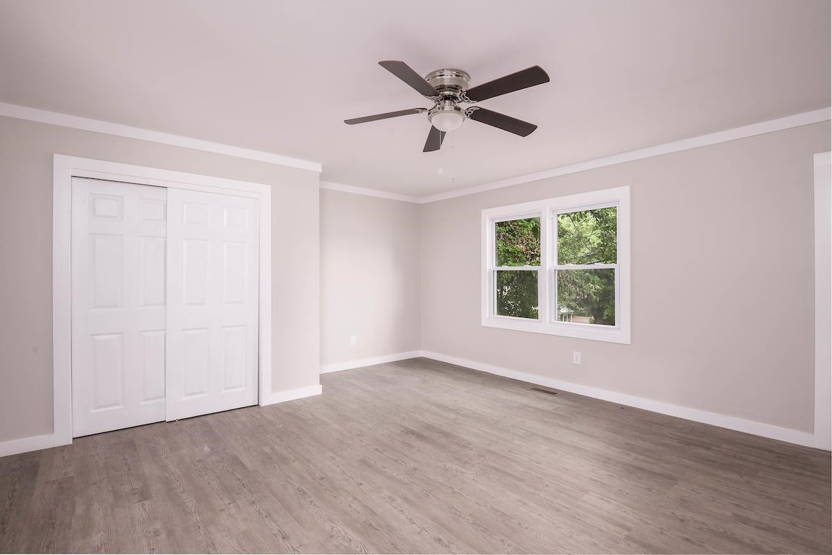 314 Depot Street Roxboro, NC 27573 - Photo 23 of 35 a view of a livingroom with a ceiling fan and wooden floor